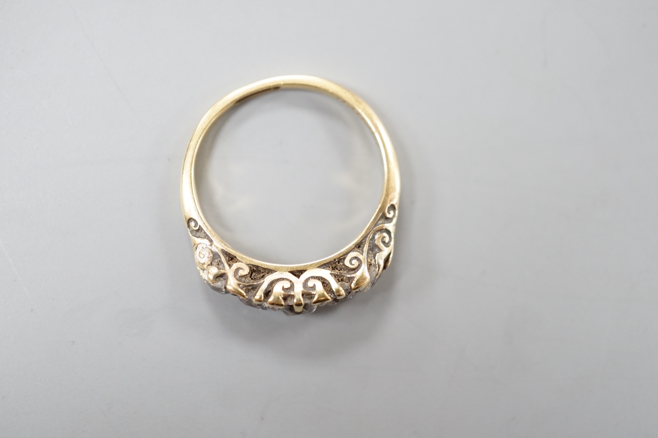 An 18ct and graduated five stone diamond set half hoop ring, size M, gross weight 3.5 grams.